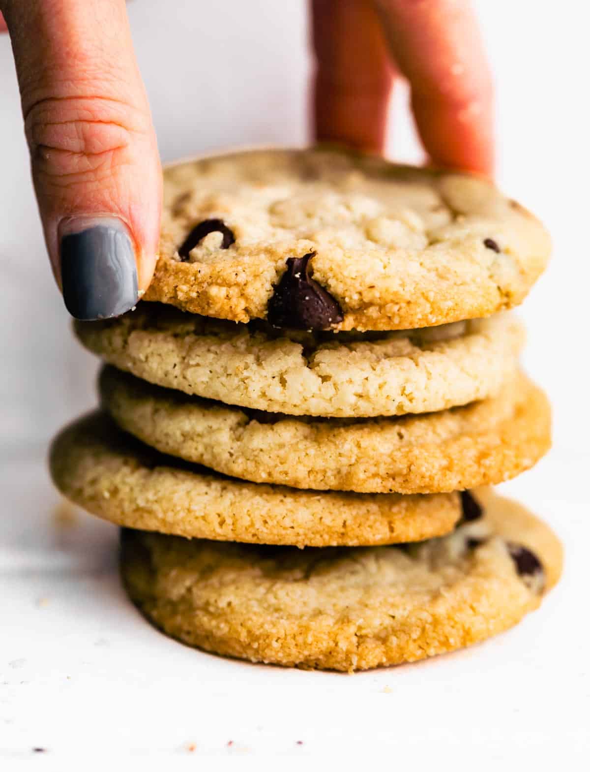 Hand picking up a Chocolate Chip Cookie.