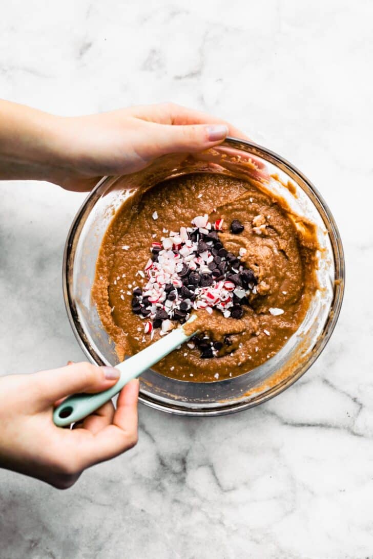 A festive bowl of batter made with cocoa powder and almond flour for gluten free Peppermint Chocolate Muffins.