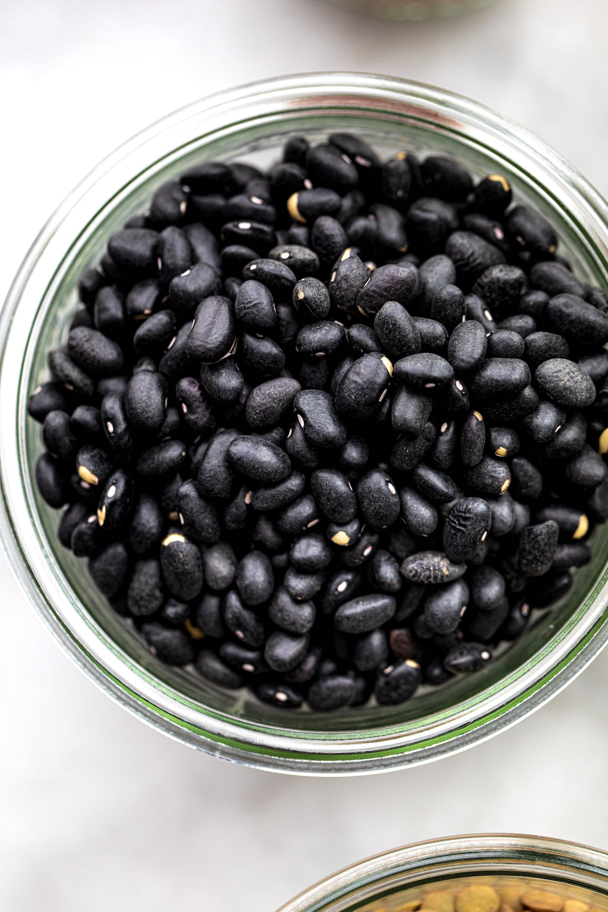 Zoomed in overhead shot of Black Beans in a glass jar.