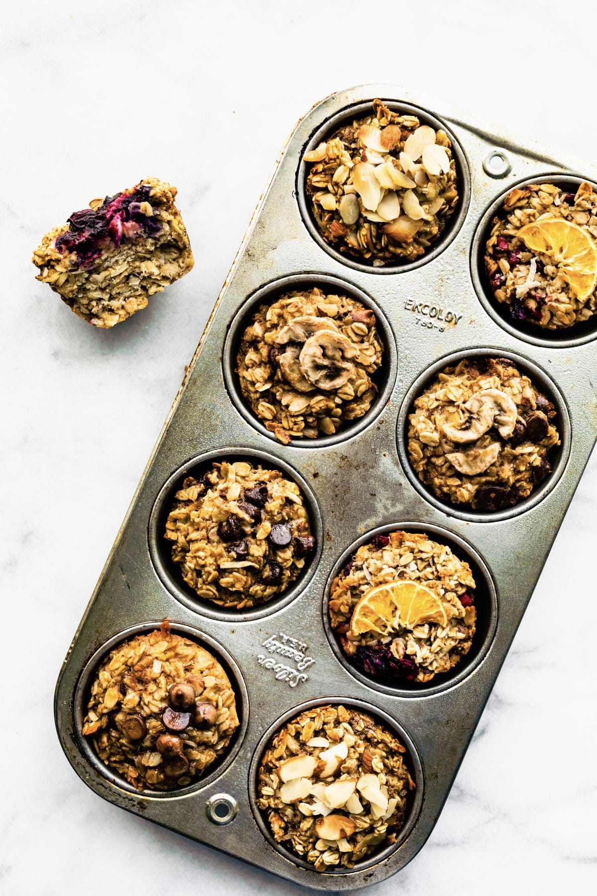 8 Assorted Baked Oatmeal Cups in muffin tin on counter top.