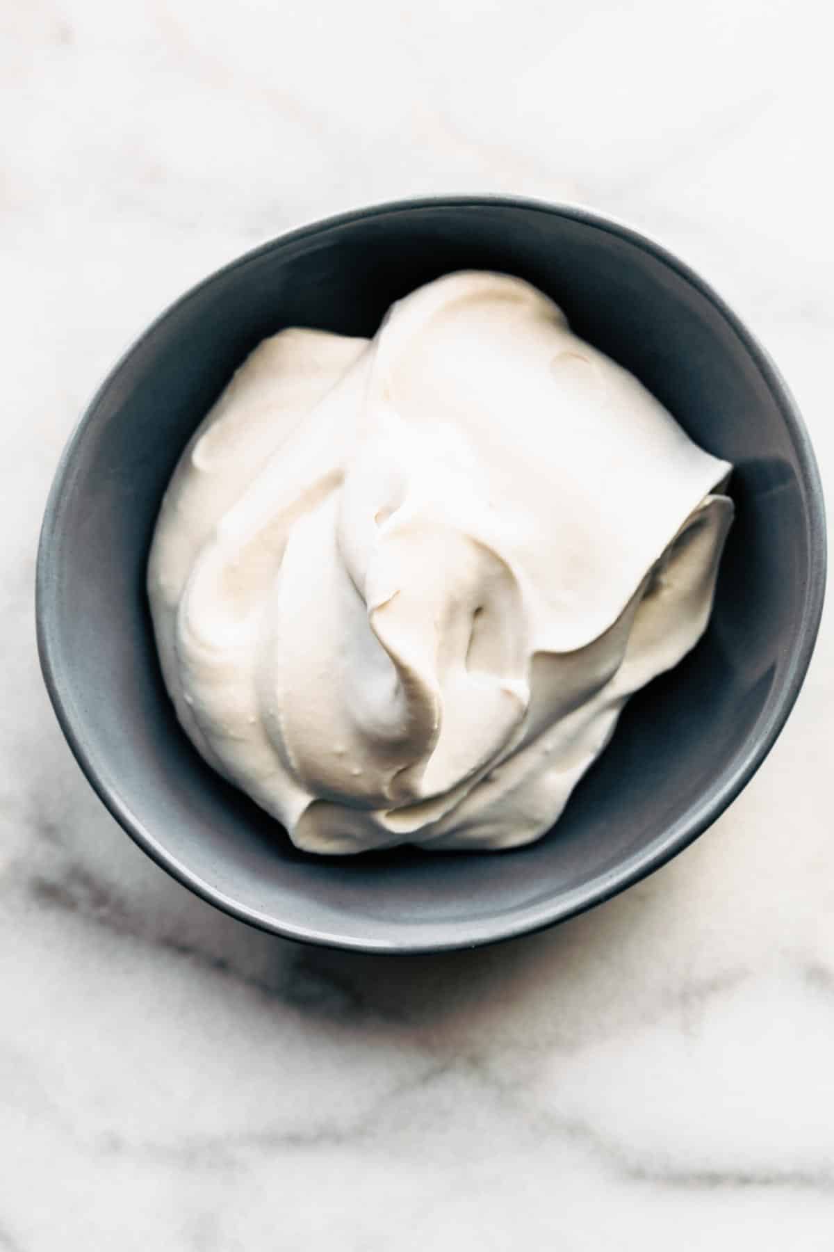 Freshly whipped cream in a bowl