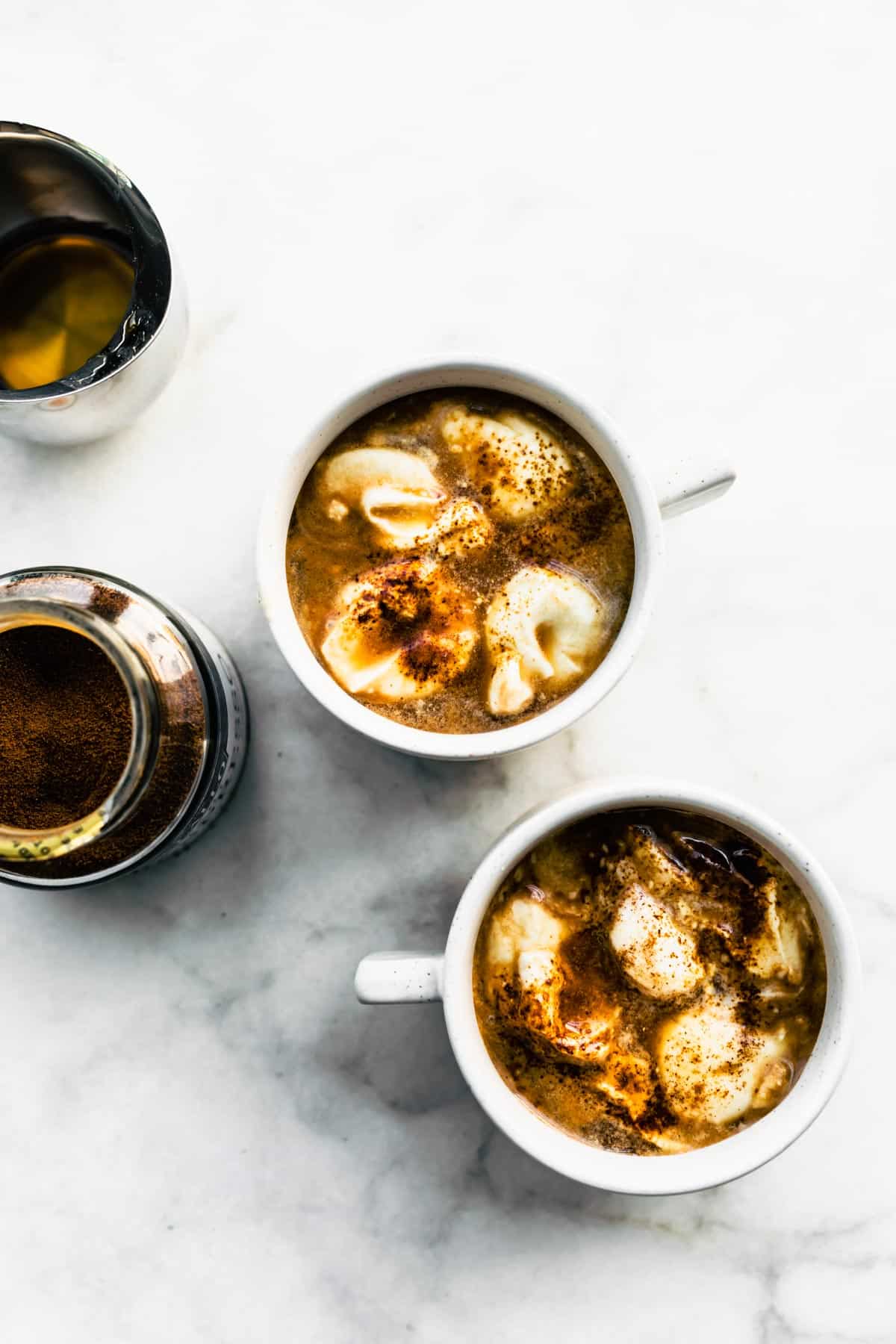 Two mugs of Espresso Con Panna with a caramelized topping