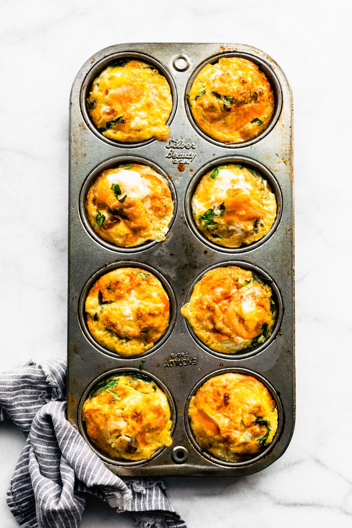 Cooked Frittata Muffins in a muffin pan.