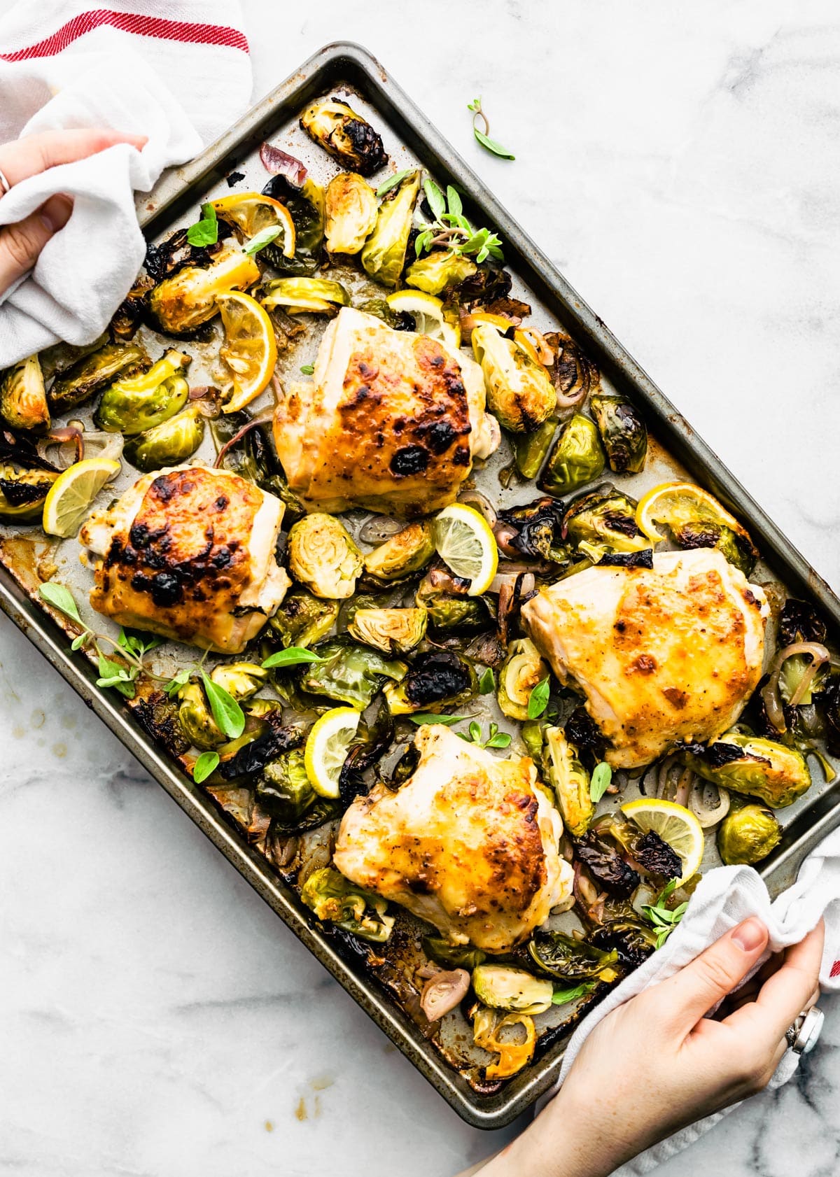 Honey Mustard Chicken Thighs with Brussels Sprouts on a sheet pan that just came out of the oven.