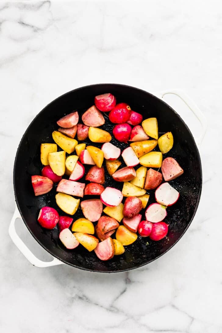 radishes and potatoes in a pan