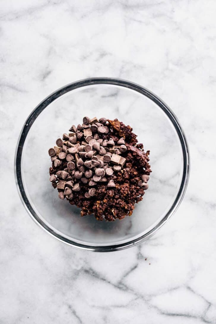 A bowl of chocolate nut-free protein ball batter with chocolate chips on top.
