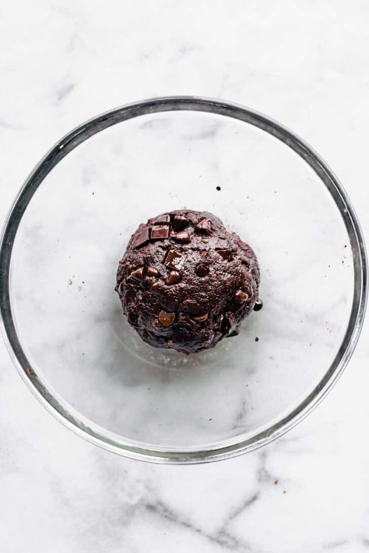 Chocolate Nut-Free Protein Balls batter with chocolate chips in a large ball in a glass mixing bowl.