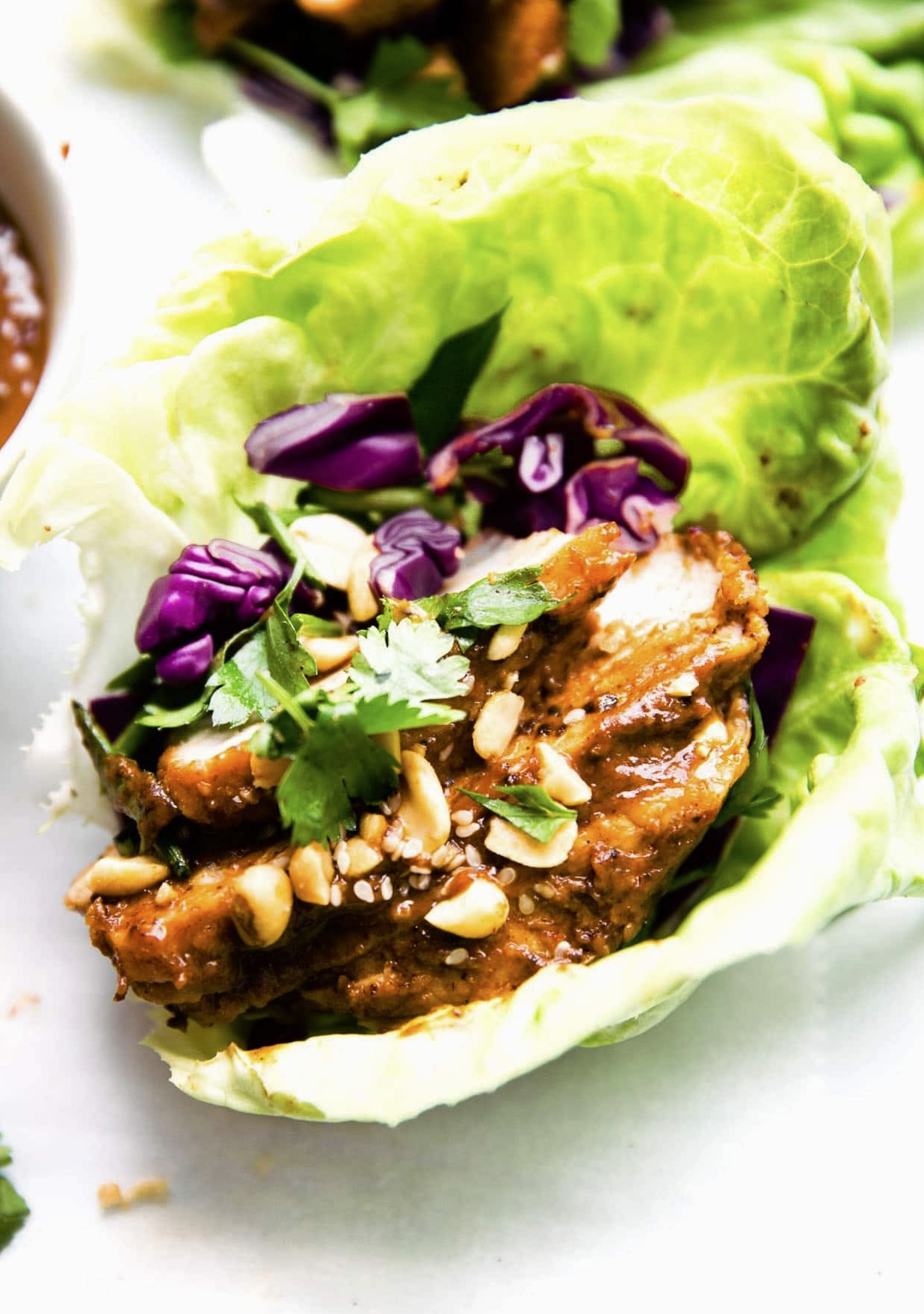 A lettuce wrap filled with Asian BBQ pork.