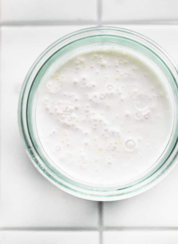 Overhead image of homemade coconut milk yogurt fermenting.