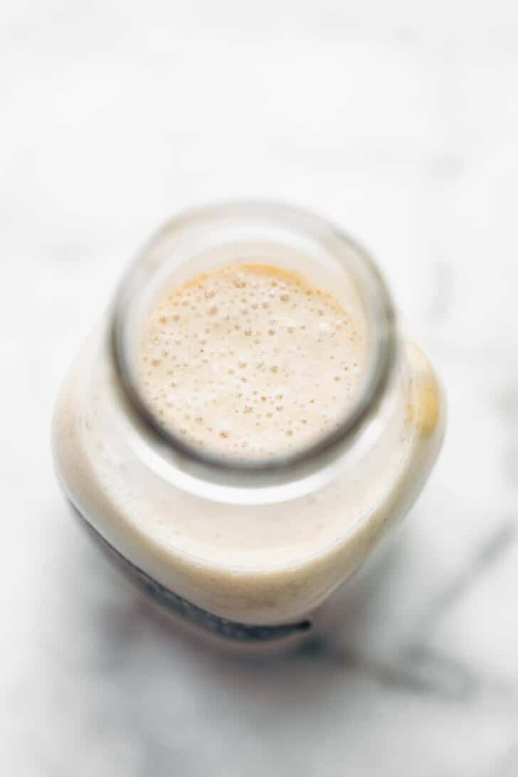 Overhead image of a glass bottle of vegan buttermilk.