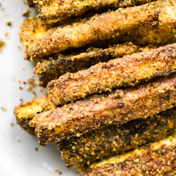 Close up image of cooked breaded air fryer zucchini fries.