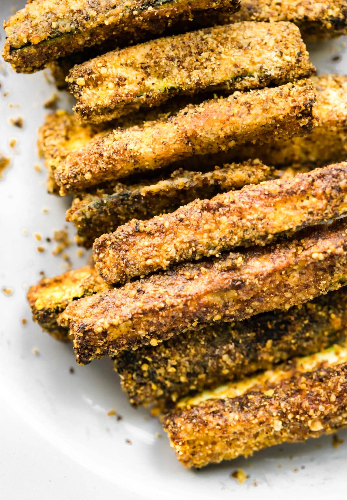 Close up image of cooked breaded air fryer zucchini fries.