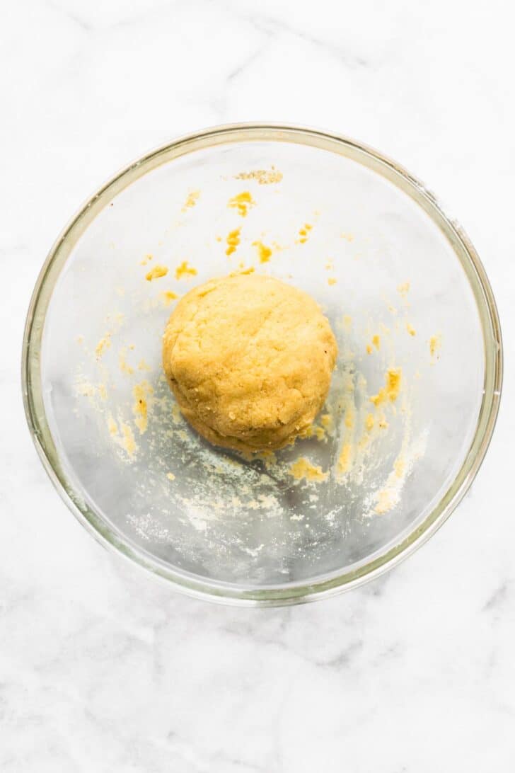 Almond flour tortilla dough in a glass bowl.