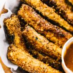 Air fryer fries in a basket lined with parchment paper.