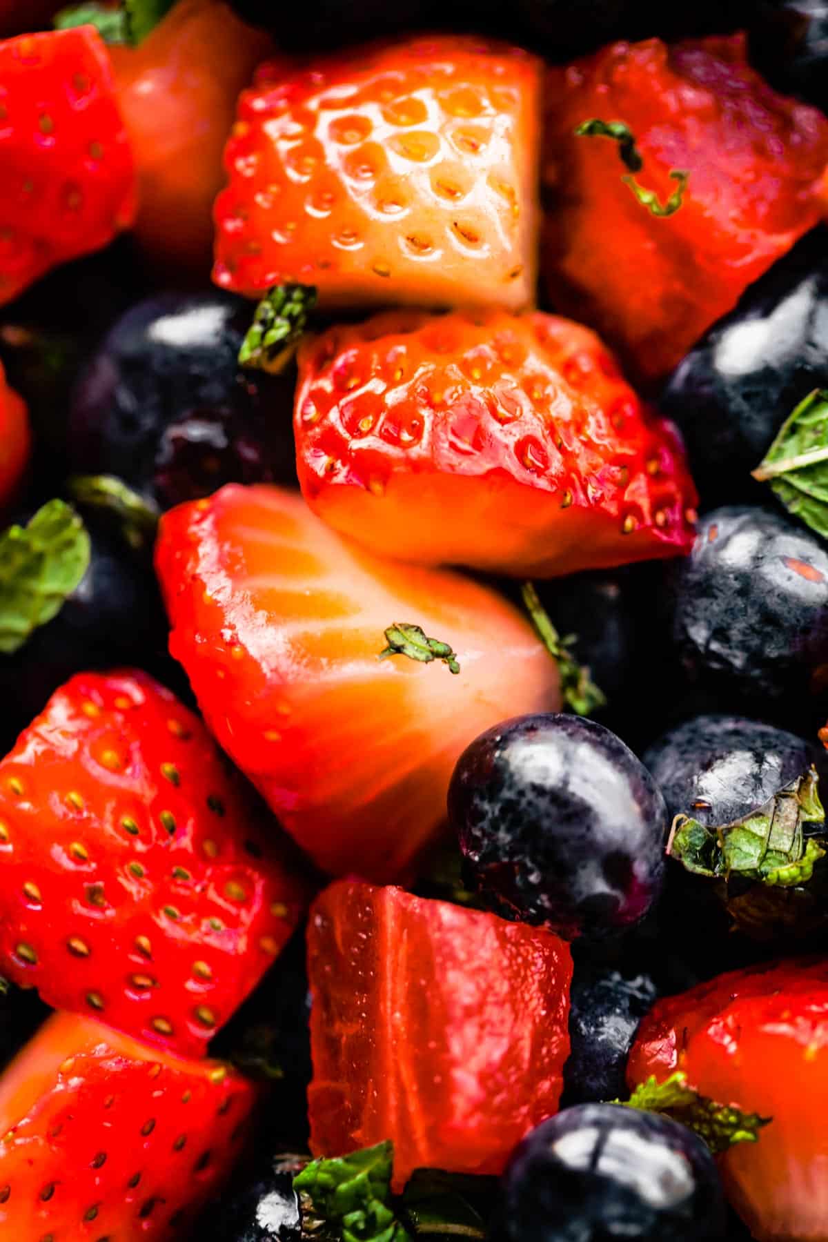 Close up image of strawberries and blueberries in summer berry salad.