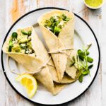 Two gluten free green goddess chicken salad wraps on a plate.