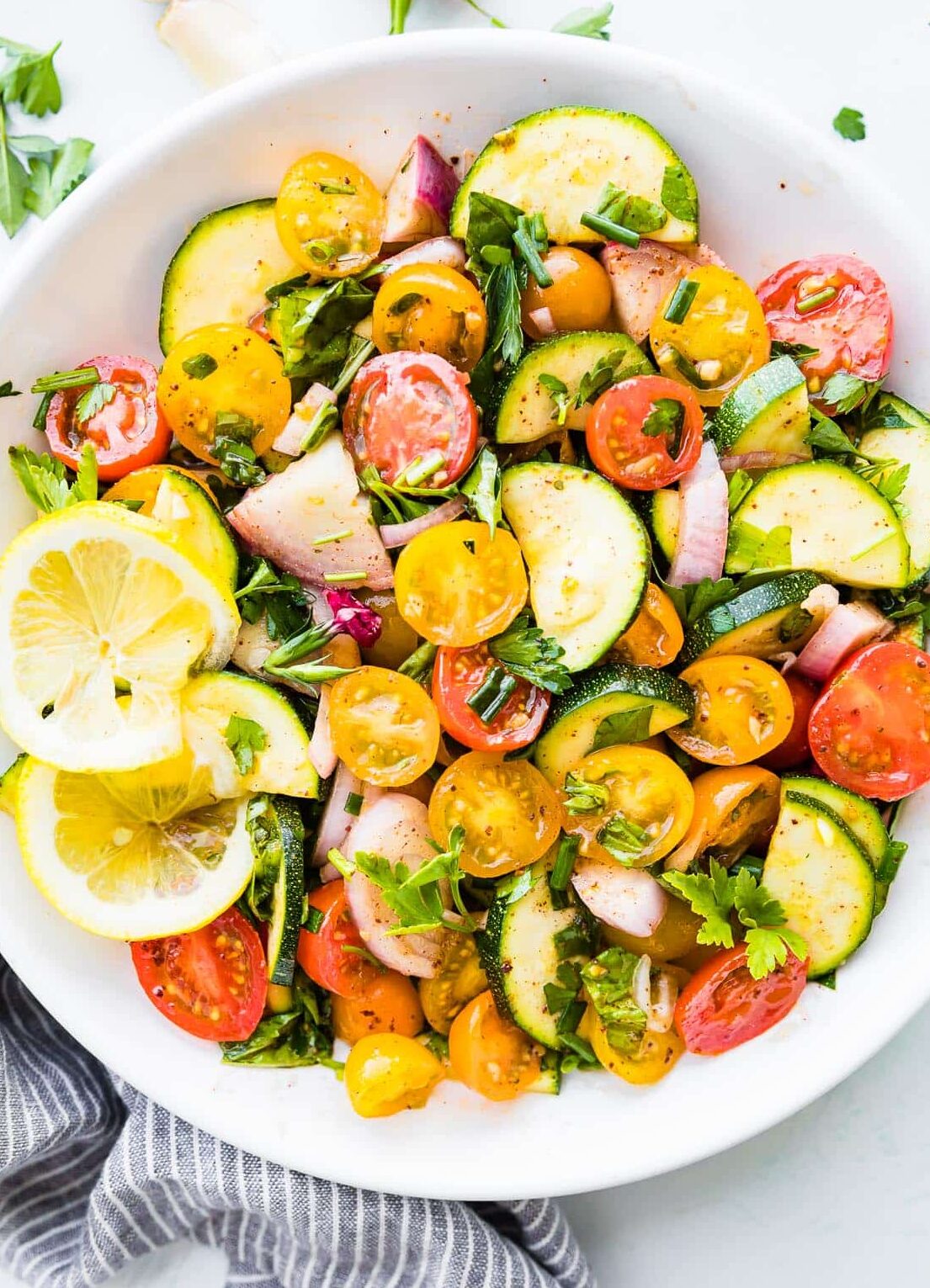 healthy marinated vegetables salad with tomatoes and zucchini.
