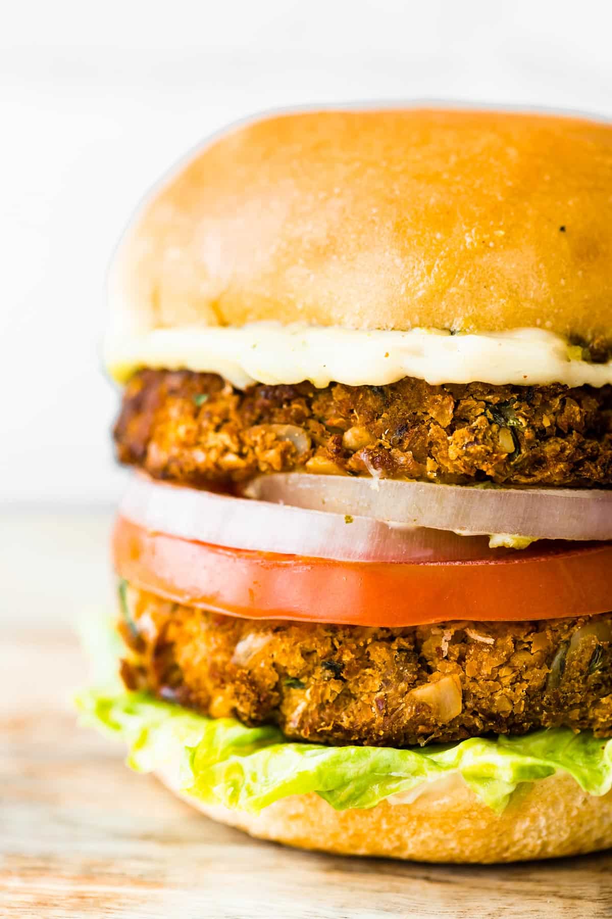 An up close photo of a gluten free cauliflower chickpea burger with all the fixings.
