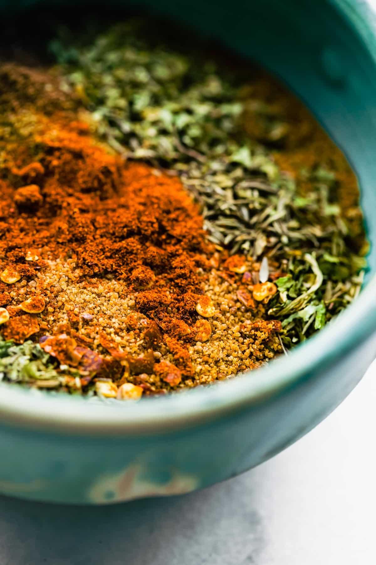 An up close view of spices in a bowl to make jerk seasoning.