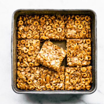 A pan of gluten free cereal bars with the middle piece sitting askew.