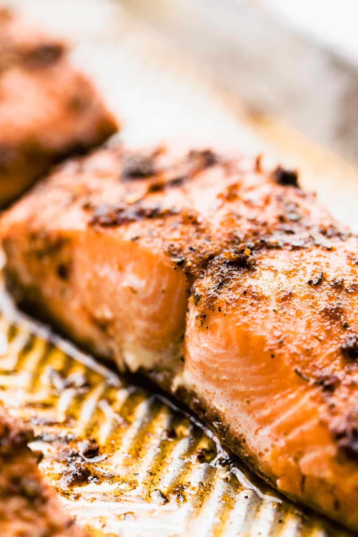 Up close side view of baked salmon with jerk seasoning.