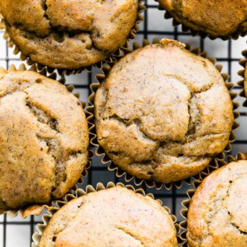 Overhead view of healthy peanut butter banana muffins on a cooling rack.