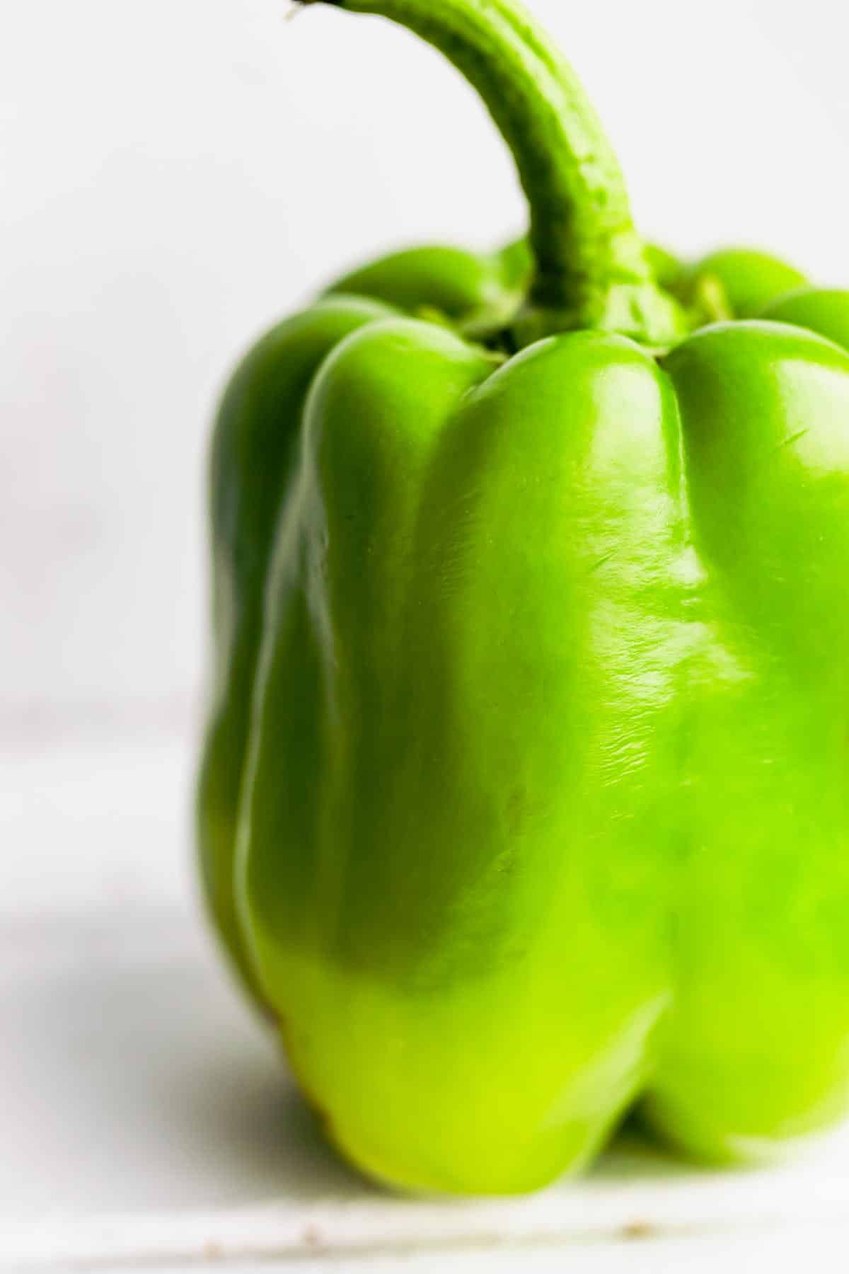 An up close shot of a ripe green bell pepper for air fryer stuffed peppers.