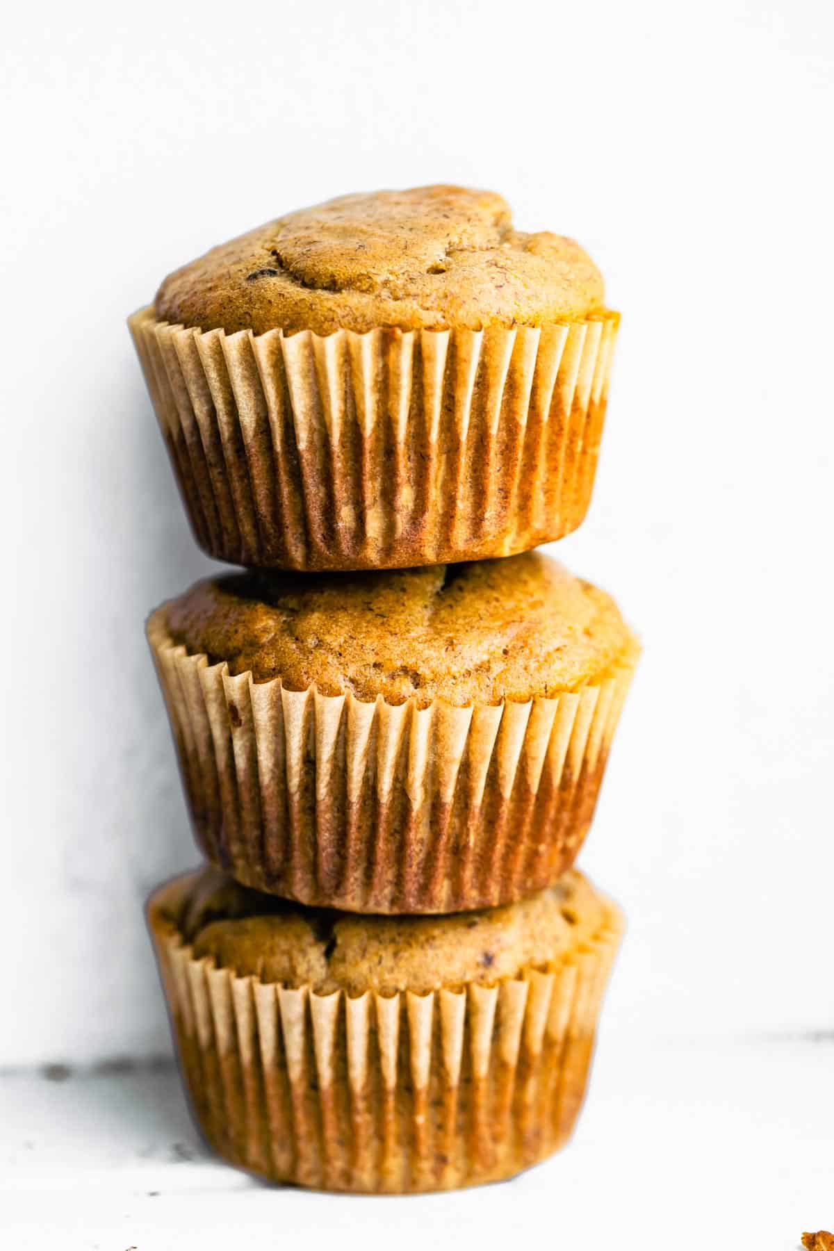 A stack of three healthy peanut butter banana muffins.