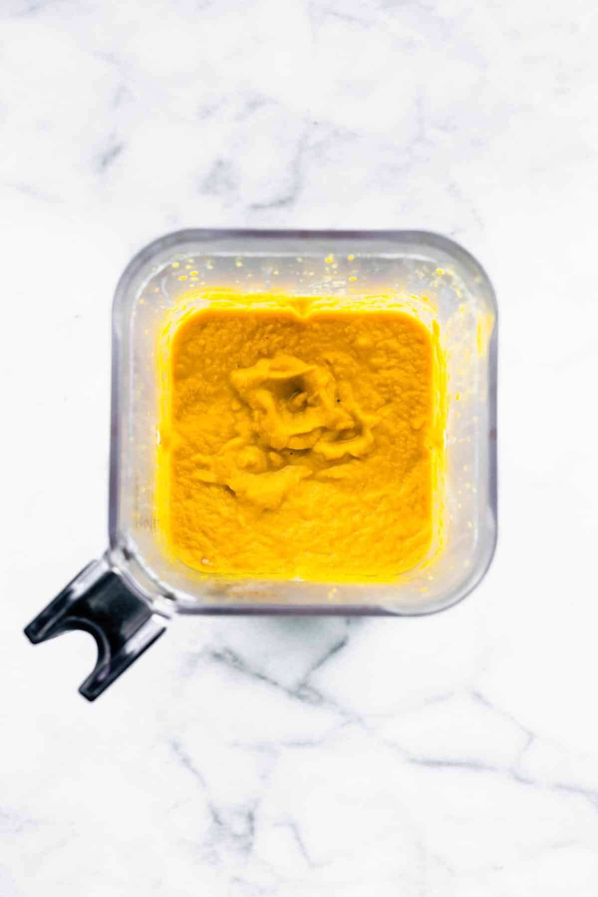 Thai curried carrot ginger soup blended until smooth in a clear blender.