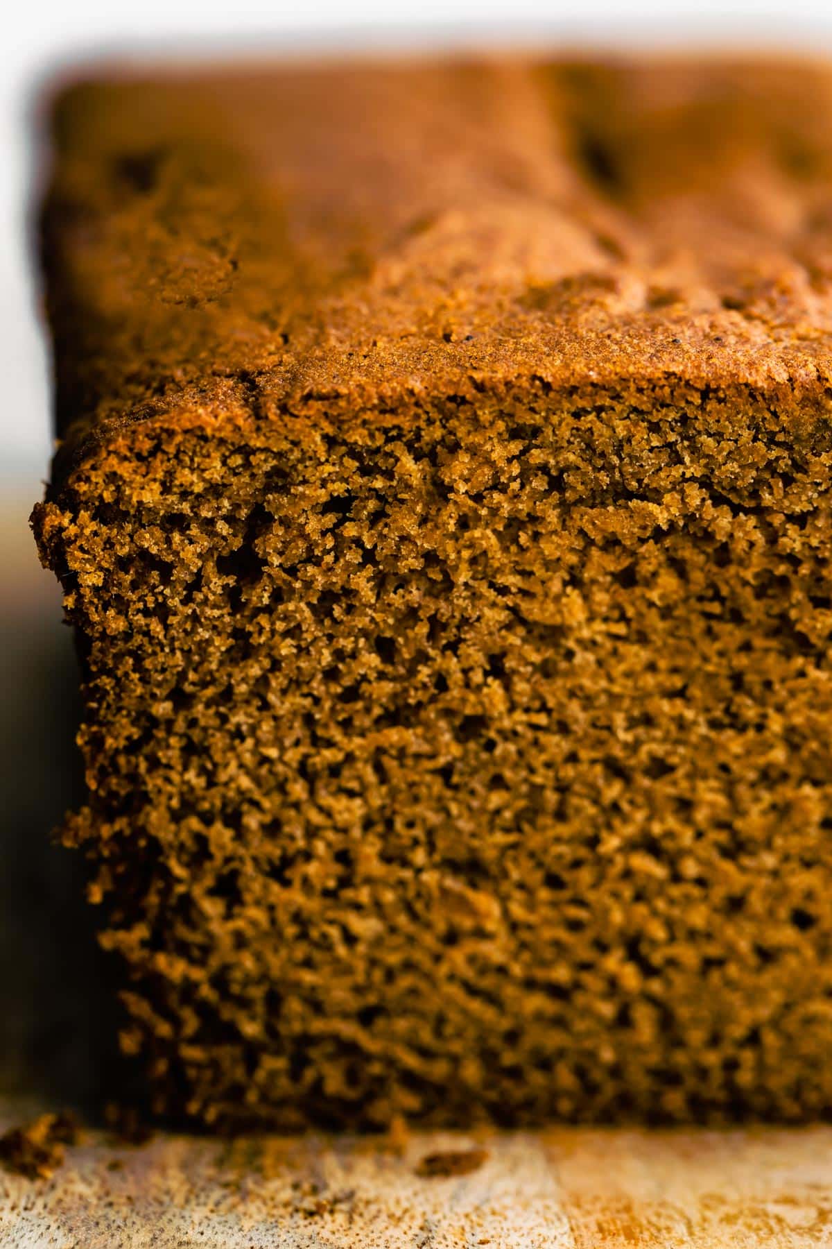 Up close photo of the crumb of a gluten free gingerbread loaf.