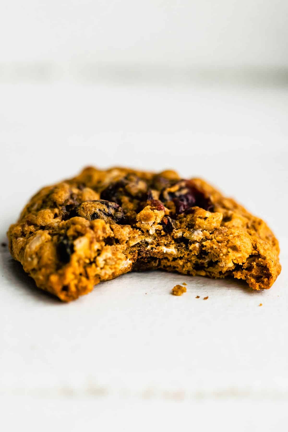 Up close photo of a gluten free oatmeal cookie with a bite removed.