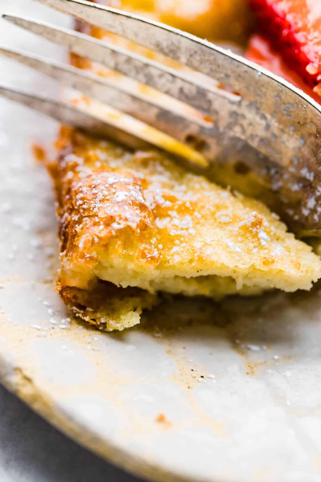 Up close photo of a fork slicing through a gluten free Swedish Pancake.