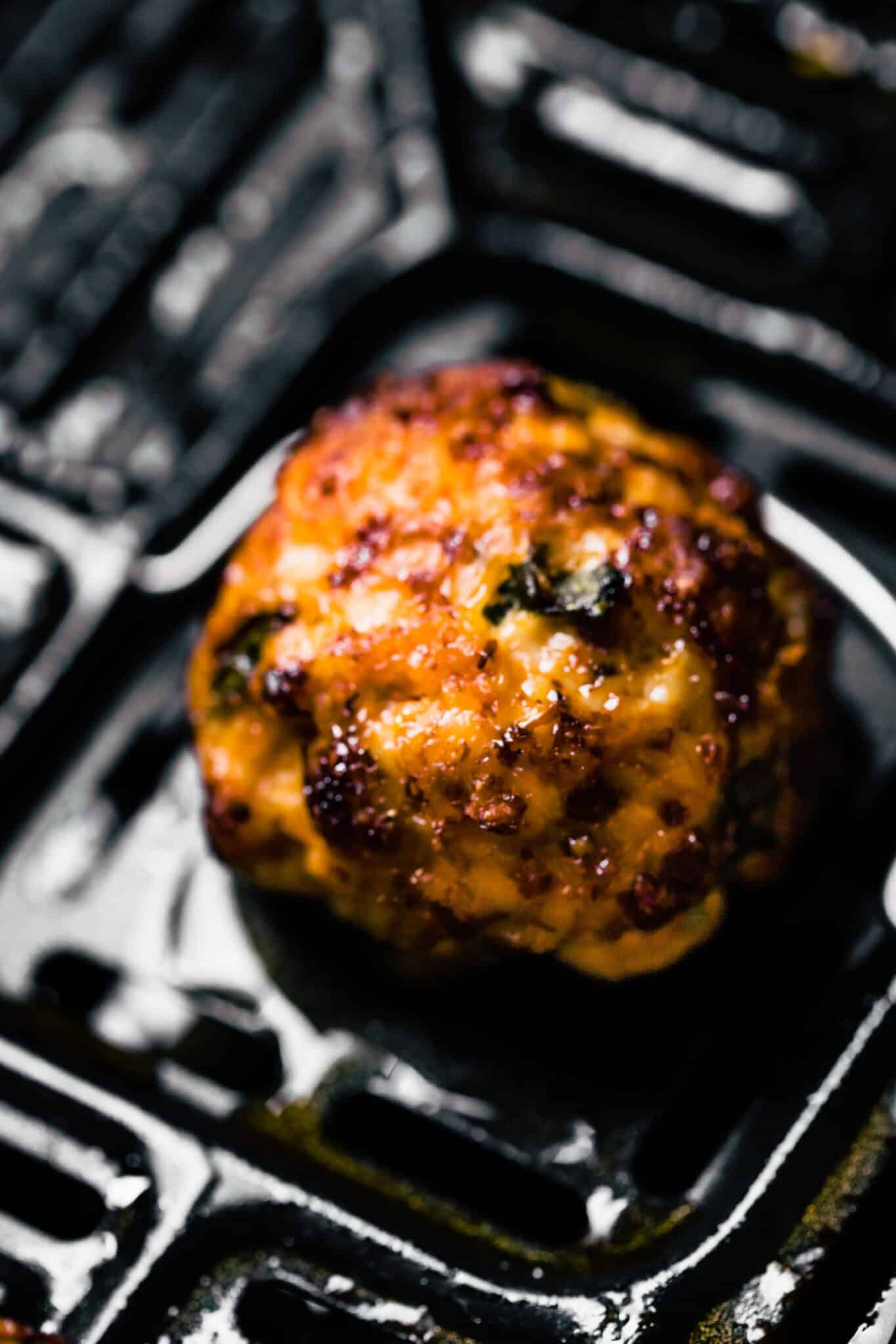 Up close photo of a gluten free chicken meatball in the air fryer.