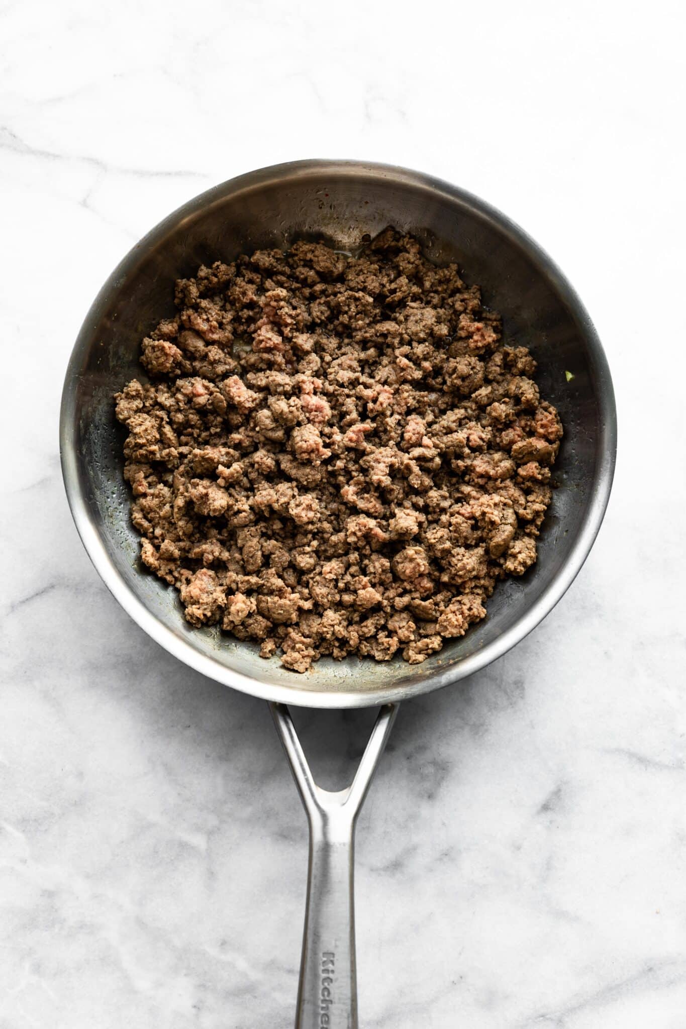 Overhead photo of browned ground beef in a pan.