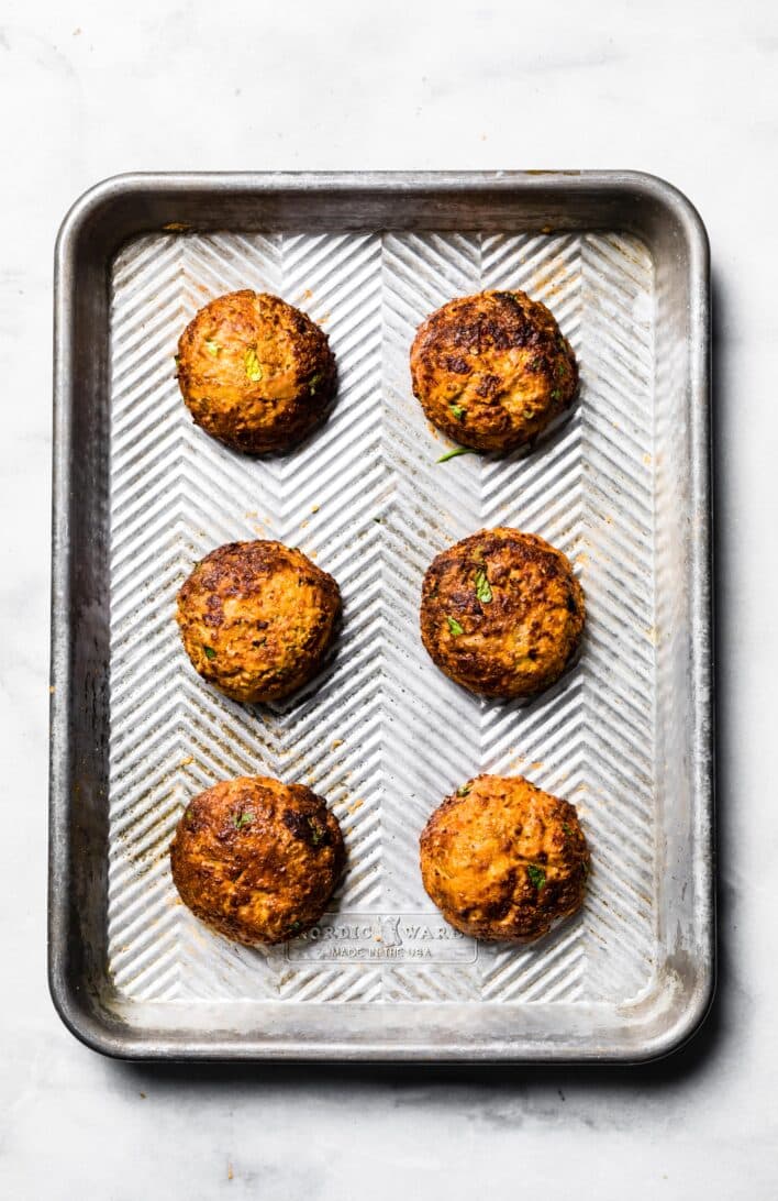 6 cooked tuna patties on silver baking sheet