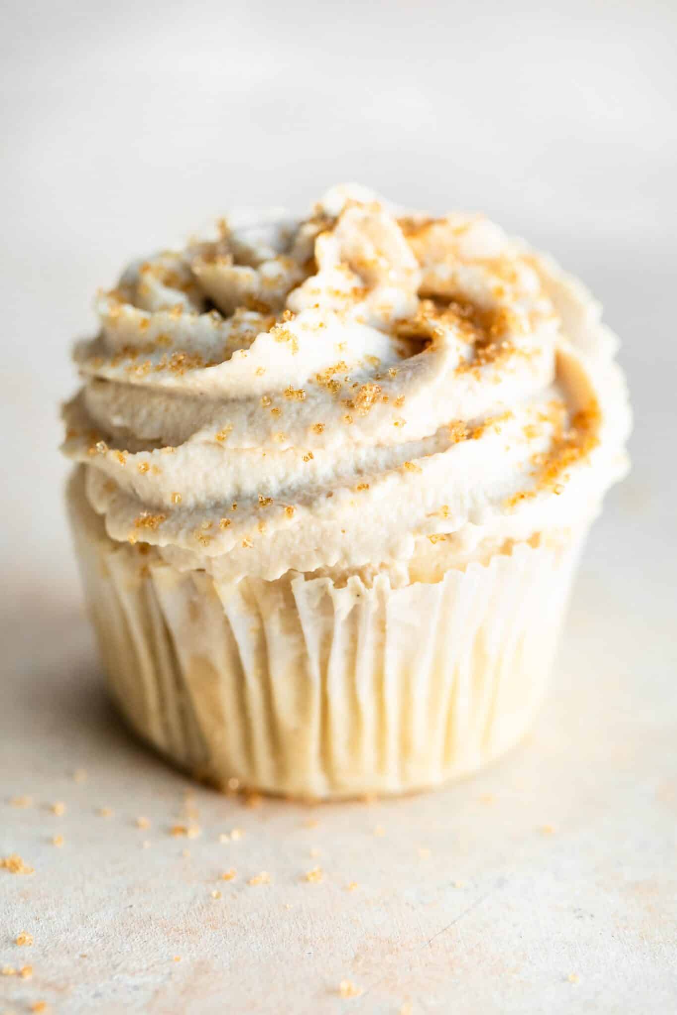 Up close photo of a gluten free vanilla cupcake frosted with cashew frosting.