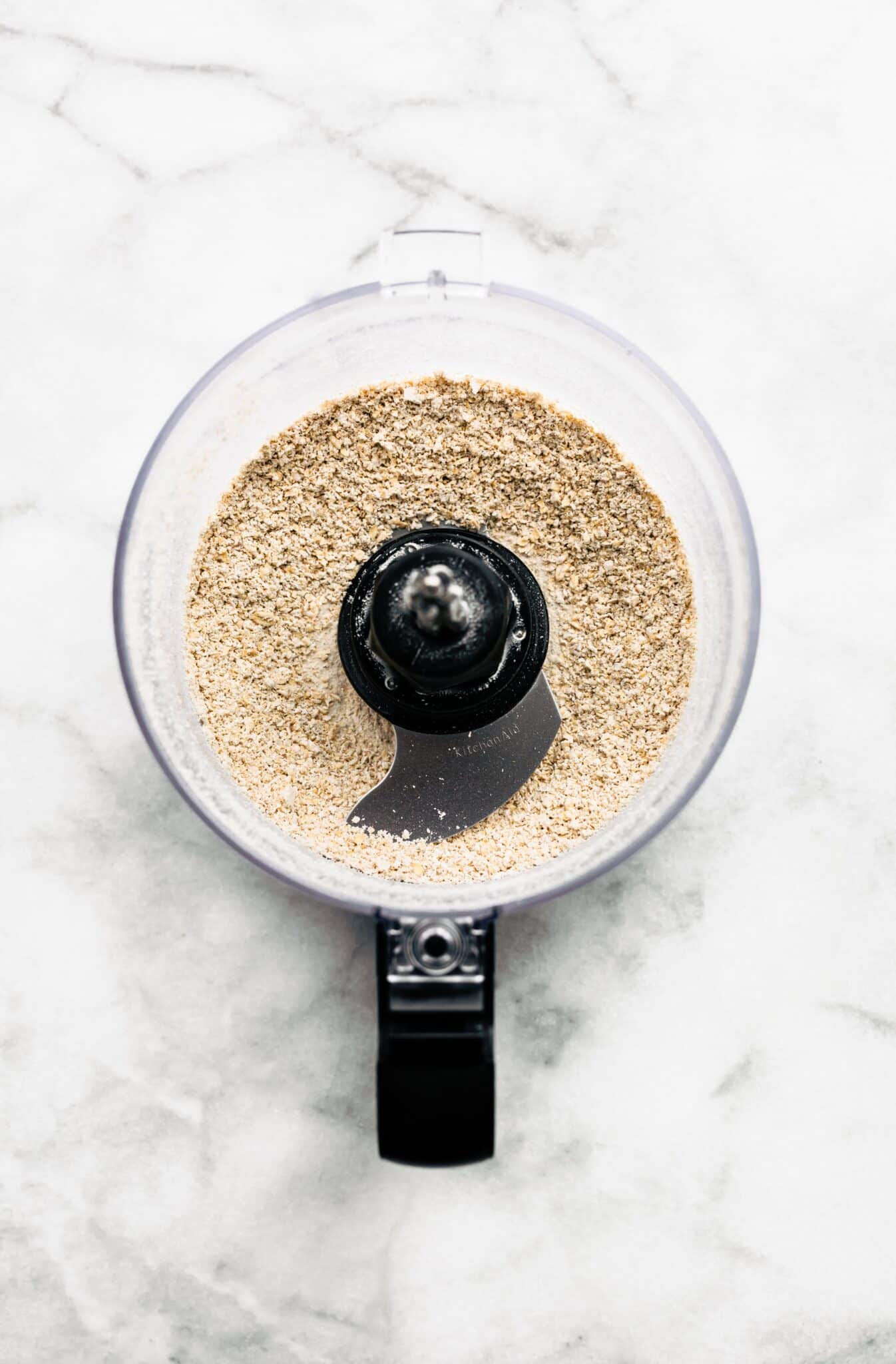Overhead photo of gluten free oats blended in a food processor.