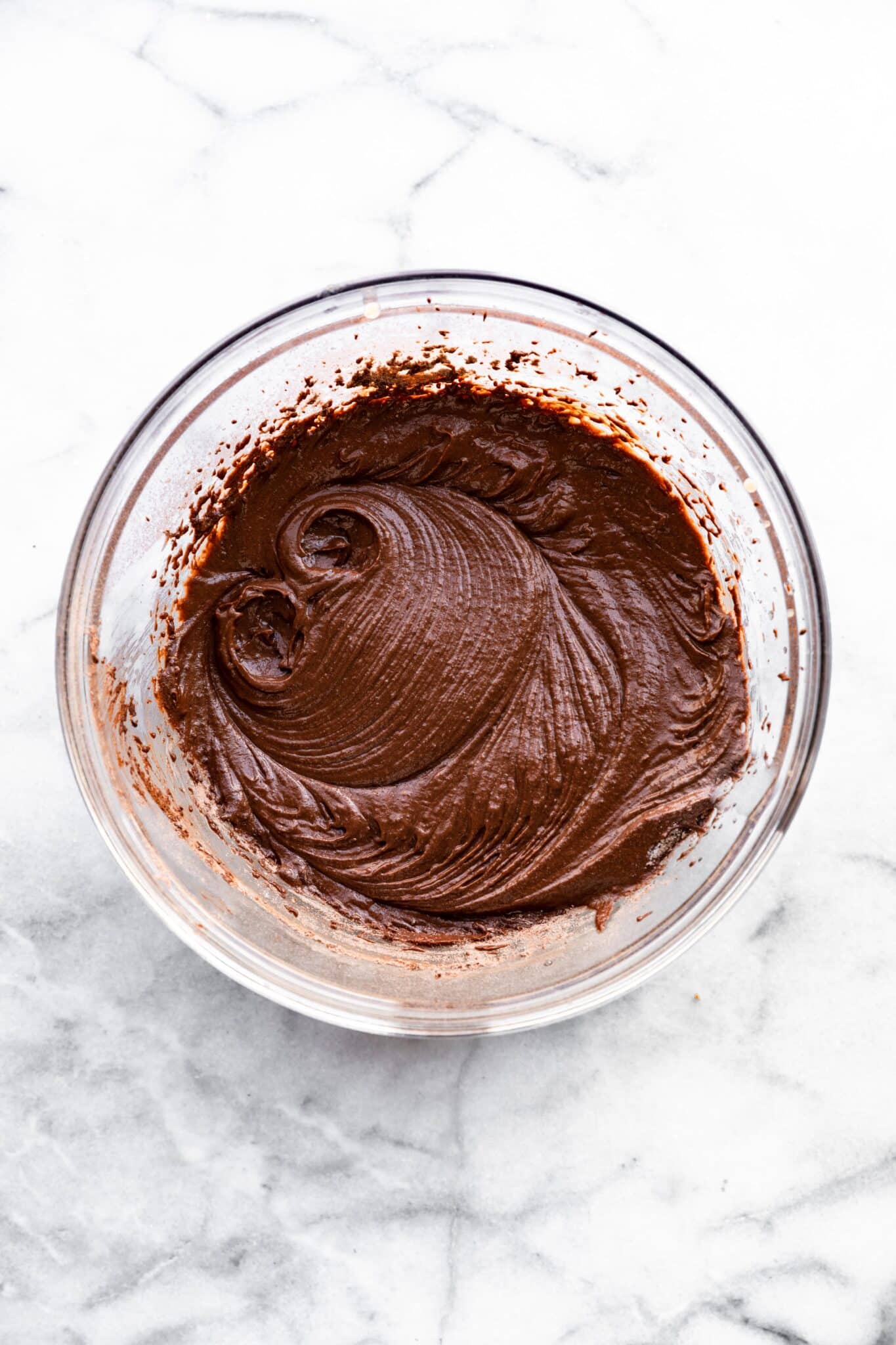 Overhead photo of easy gluten free chocolate cupcake batter in a glass bowl.