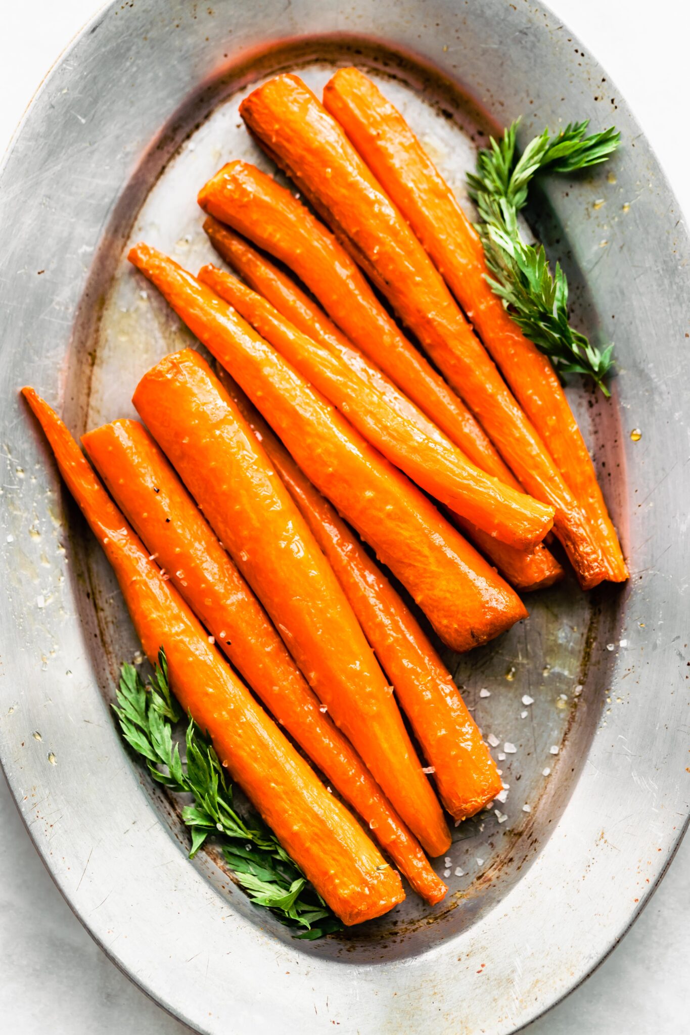 Overhead photo of Easy Maple Glazed Carrots on a silver metal platter.
