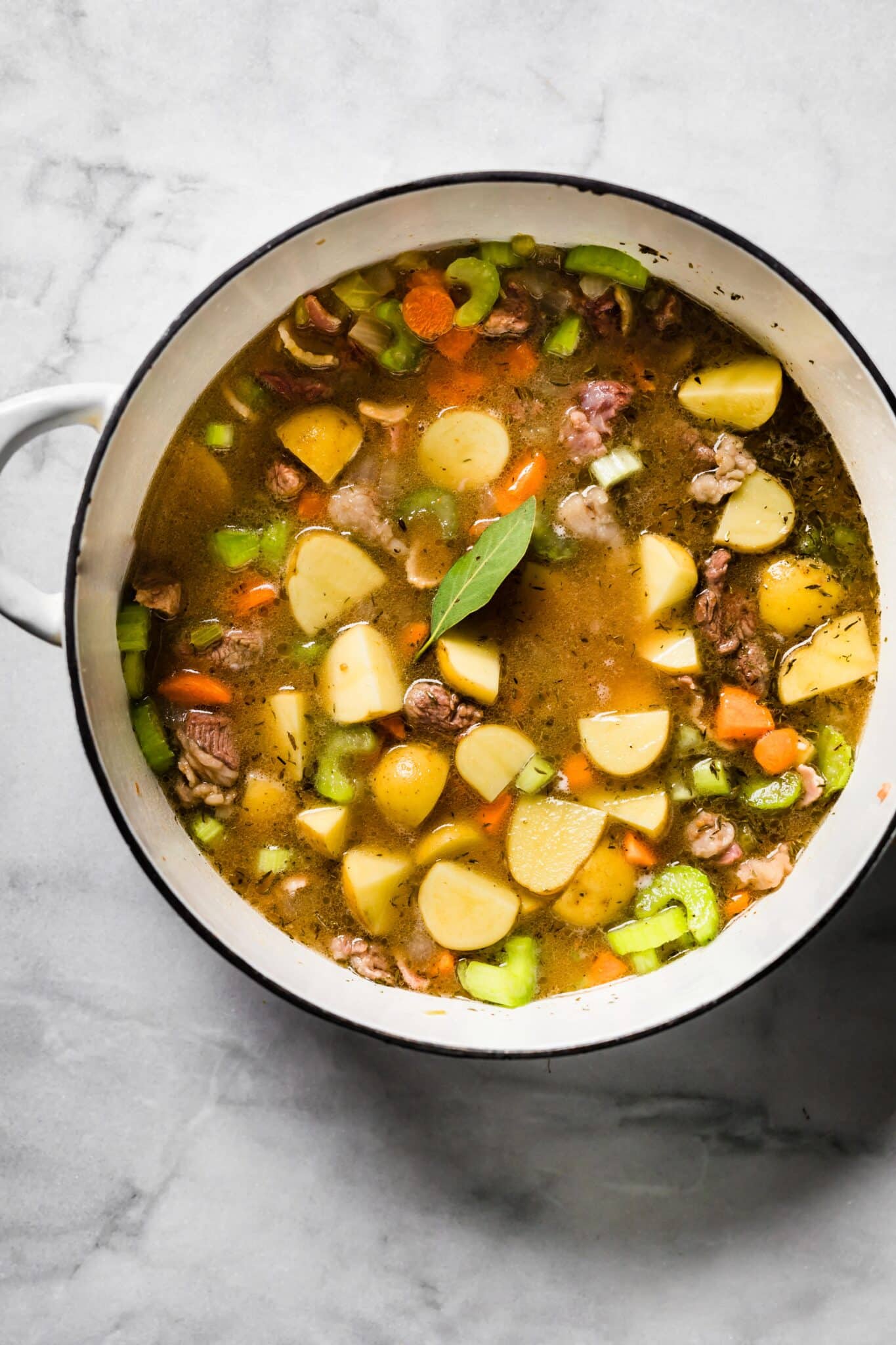 Overhead photo of one pot Irish stew with a bay leaf on top.