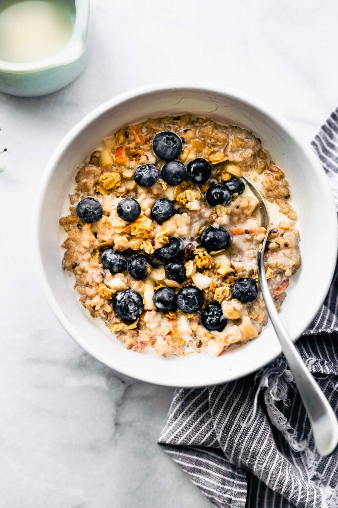 Overhead photo of oatmeal topped with blueberries and cream.