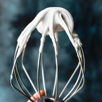 a whisk with whipped coconut cream on the end