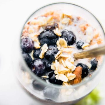 blueberries and cream superfood overnight oatmeal in a glass